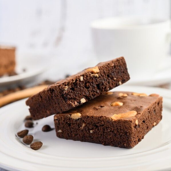 chocolate-brownies-white-plate-coffee-beans-wooden-spoon_1150-20870